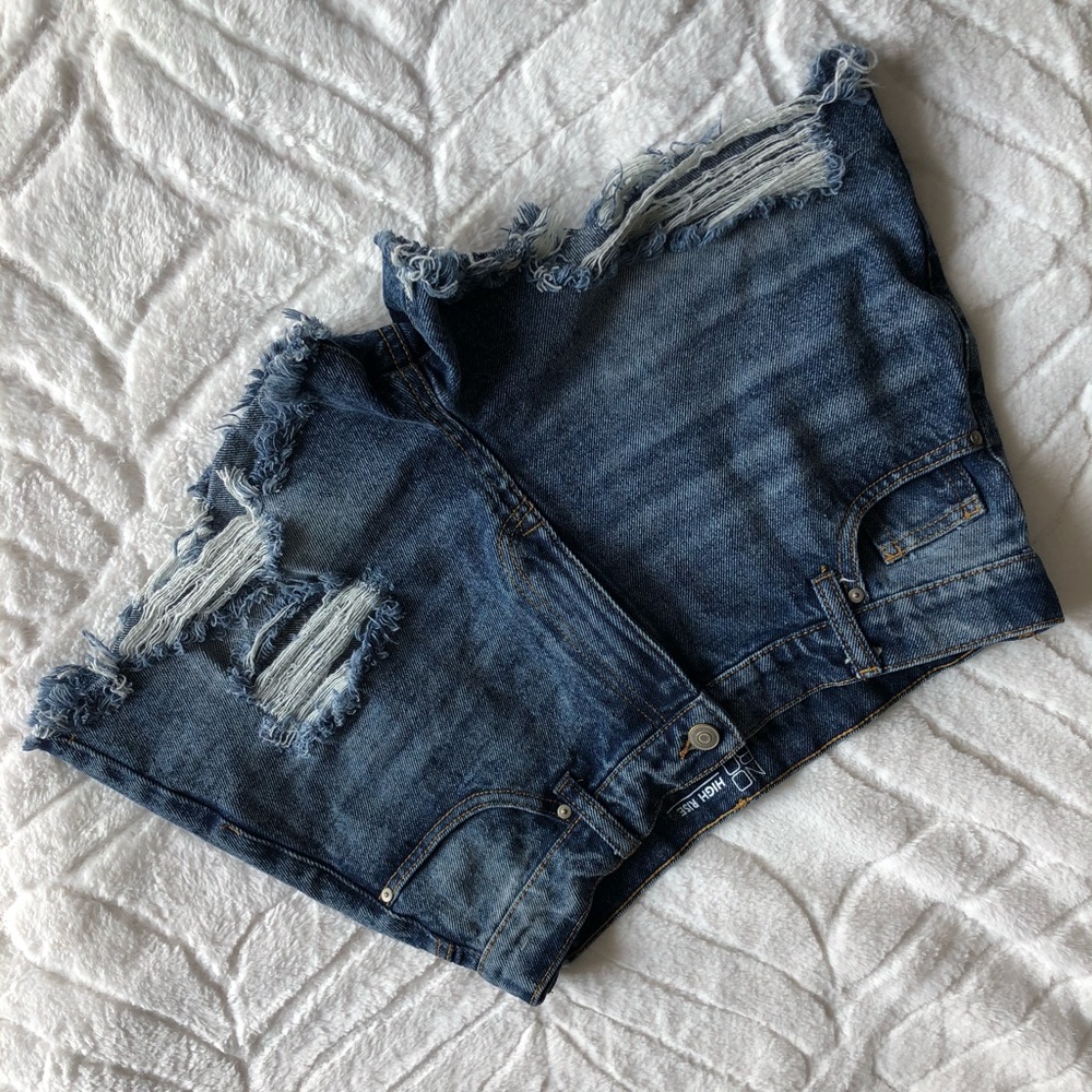 Unworn, distressed, high rise blue jeans